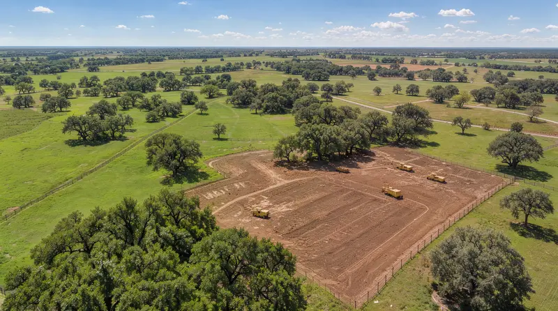Aerial view of a cleared building site among pasture and oaks, land clearing in Bell County, Texas